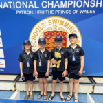 four boys with medals